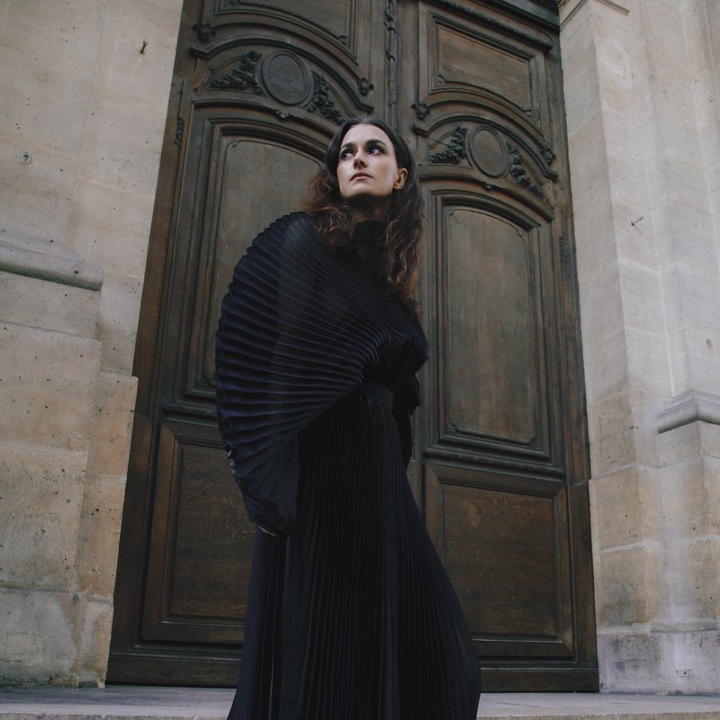 Triin Lellep — Paris doorway, black pleated gown